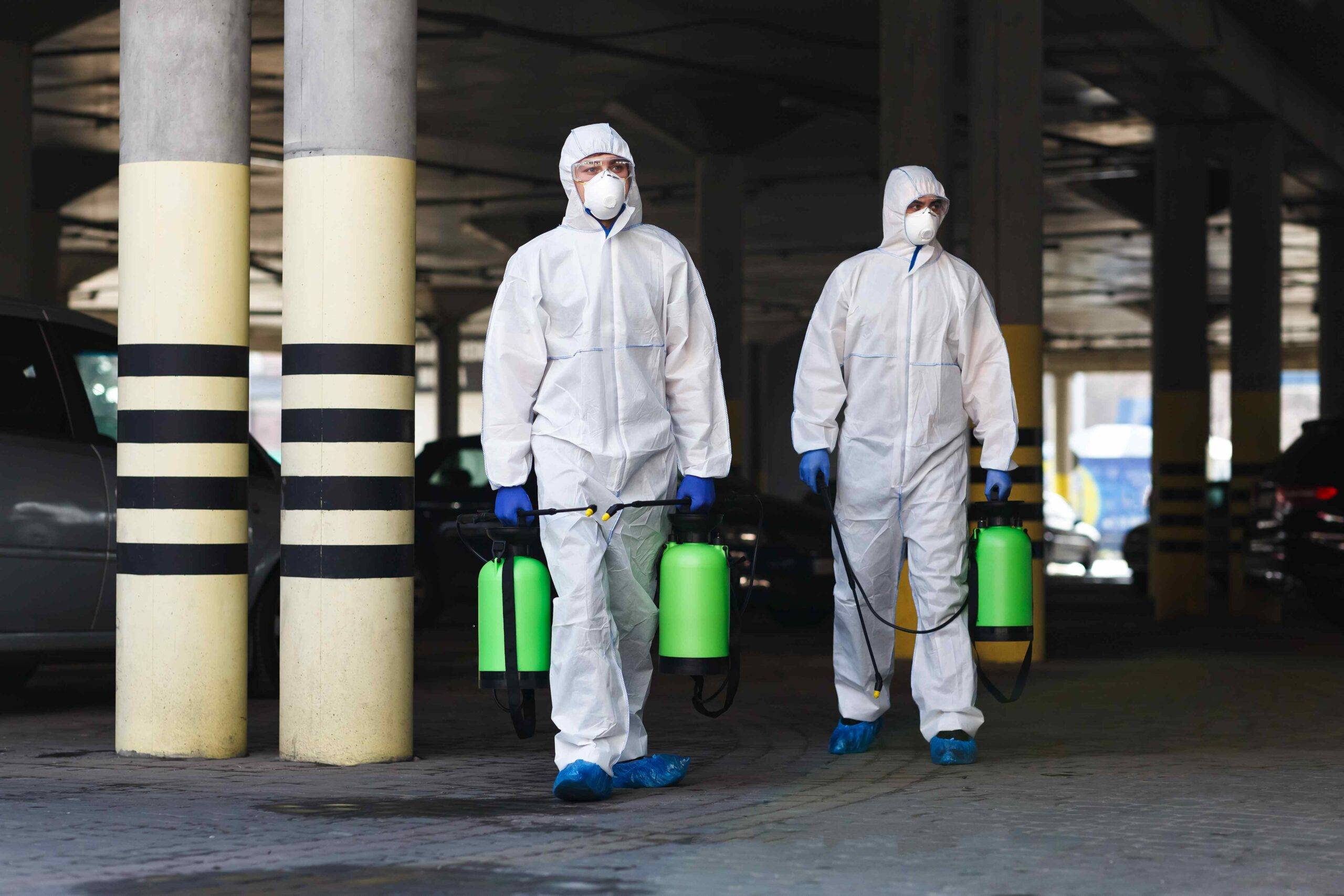 men in coronavirus suits holding disinfection chem 2022 12 16 07 24 42 utc scaled - Decon Solutions Australia Services