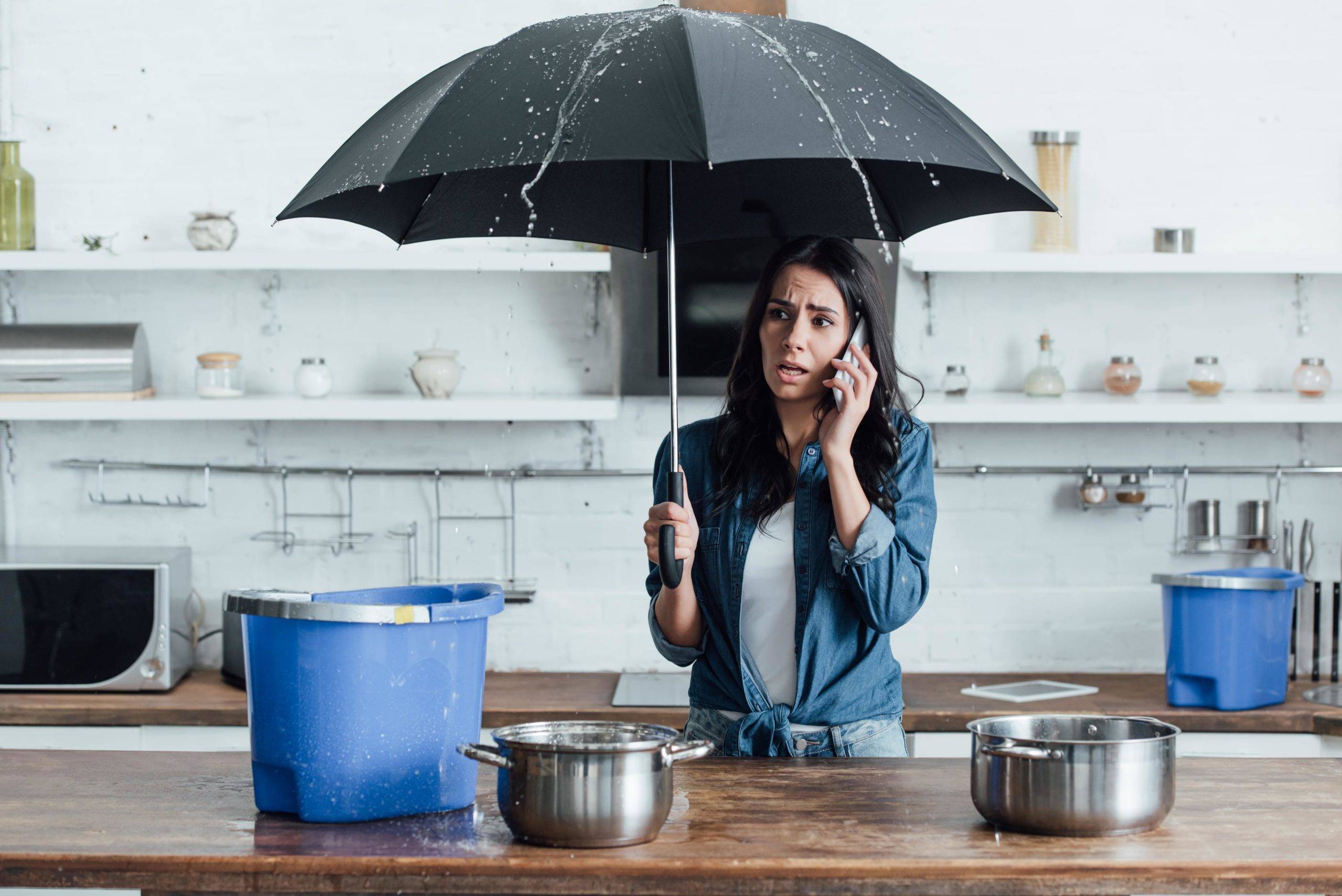 upset woman standing under umbrella in kitchen and 2022 02 03 10 42 32 utc min scaled 1 - Decon Solutions Australia Services