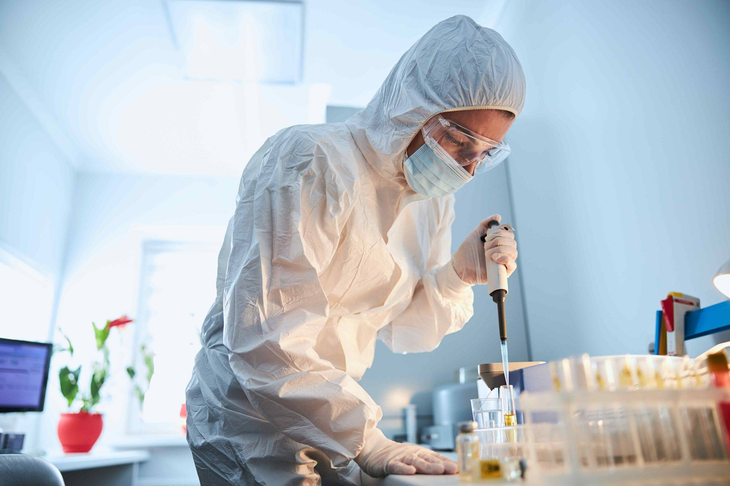 scientist leaning over the serum sample in a test 2022 03 09 03 12 27 utc scaled - Decon Solutions Australia Services